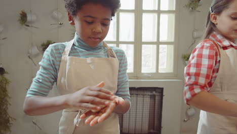 Little-Boy-Forming-Dough-on-Cooking-Masterclass