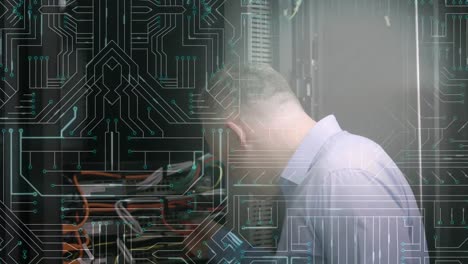 man working on computer server while glowing motherboard moves in foreground