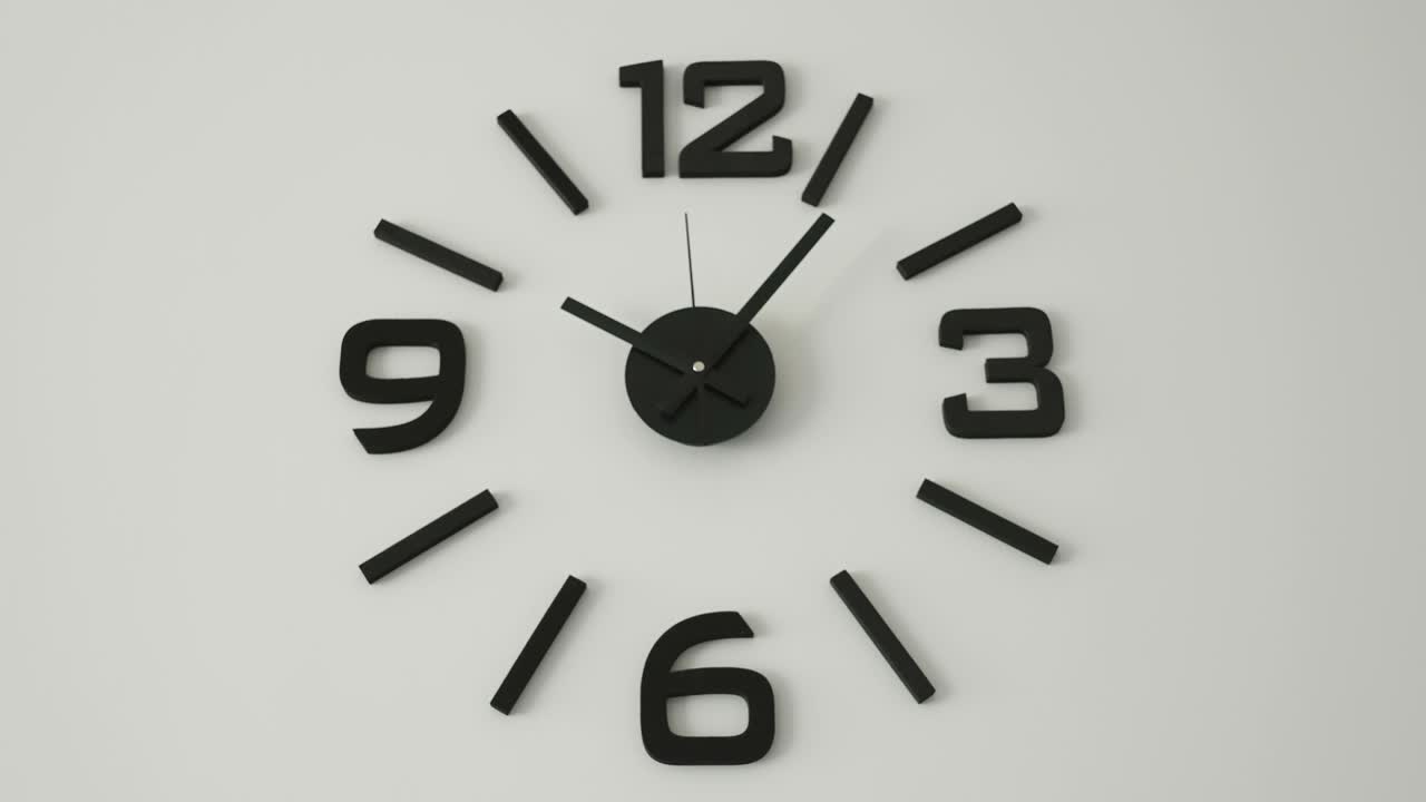 A black analog clock on the wall in Estonia
