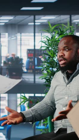 vertical video multiethnic professionals in a heated argument during corporate negotiation