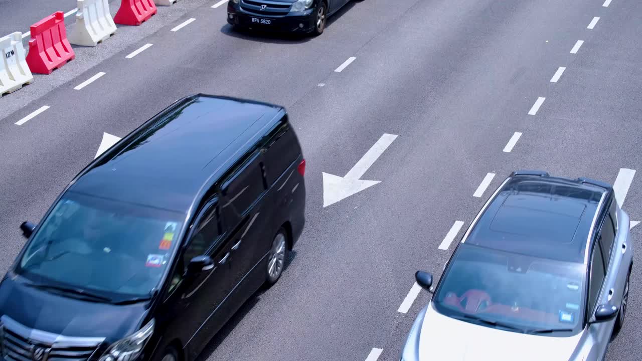 Close up view of moving cars on 3 lane highway in capital city of Kuala Lumpur Malaysia