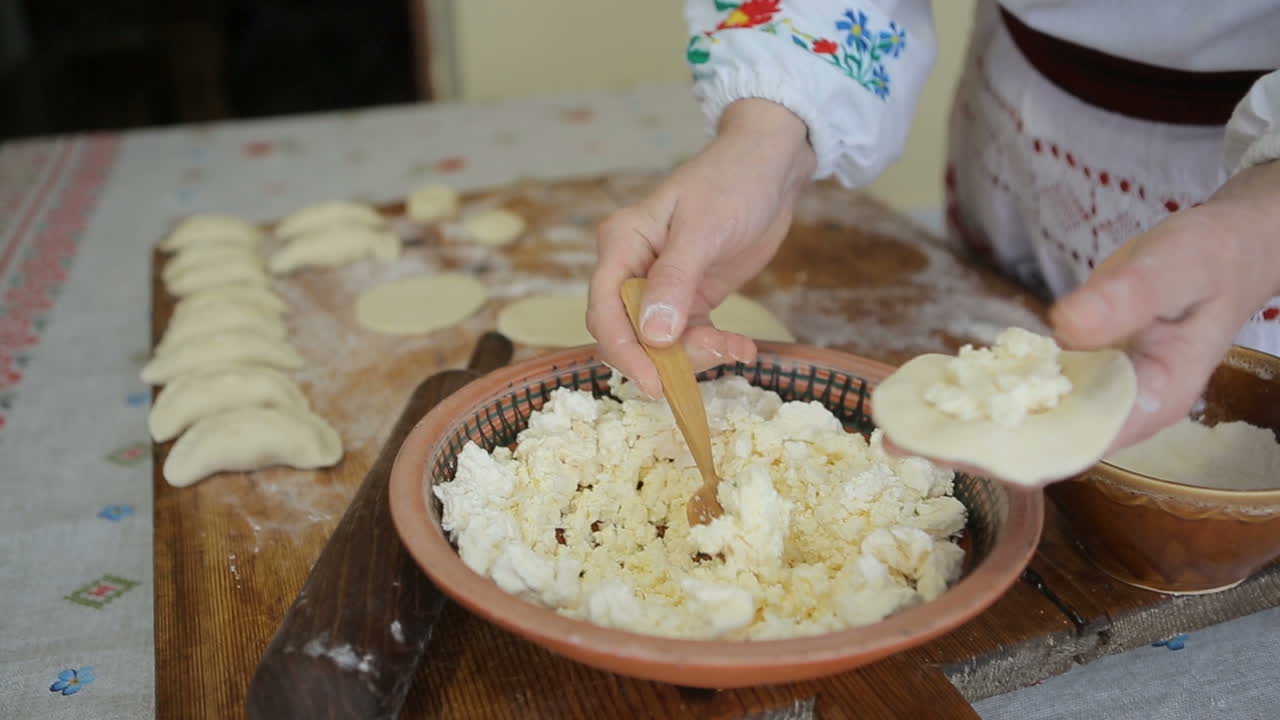 Woman hands making dumplings. Making traditional ukrainian cottage cheese dumplings