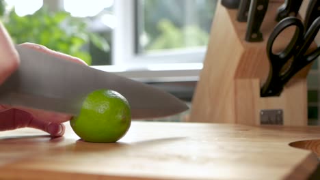 slow motion shot of a lime being cut in half