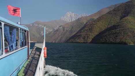 Koman-Lake-with-the-Komani-Lake-Ferry-heading-in-the-mountains-of-Albania-and-the-Alps