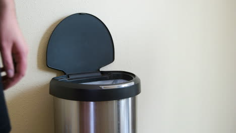 Man-Throws-Away-Banana-Peel-in-Motion-Sensing-Touchless-Trash-Can---Medium-Side