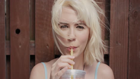 slow motion portrait of happy beautiful caucasian woman drinking juice