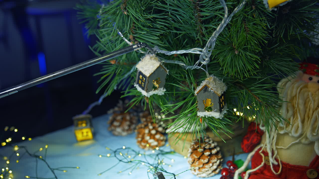 Artificial intelligence robot decorating Christmas tree. Modern robotic equipment hang toys on a fir tree. Robotic industry.