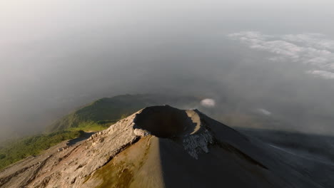 Panoramic-drone-shot-of-active-Fuego-volcano-crater-in-Guatemala-during-sunrise