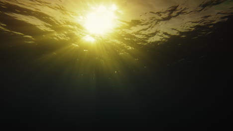 beams of god's light cross the underwater abyss in the peace of the senses