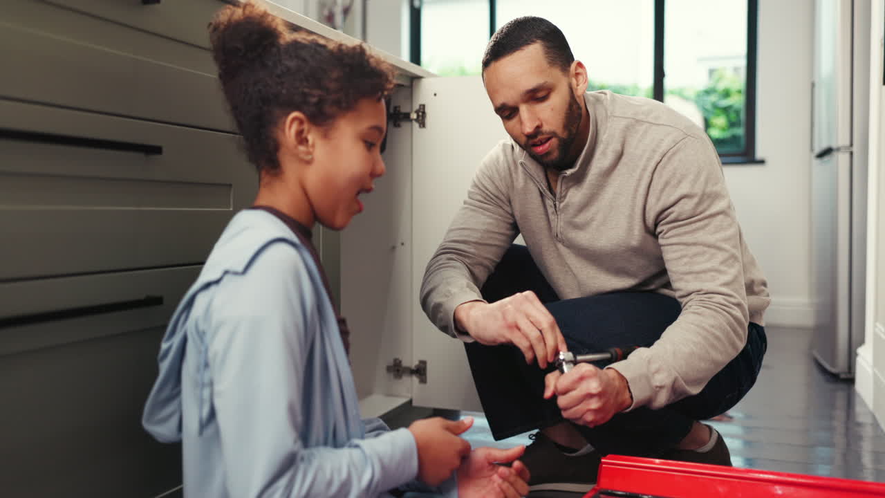 Father and Daughter Working on Home Repair Together