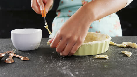 woman slicing off extra dough from the mold 4k