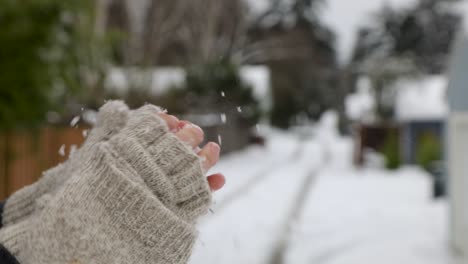 hand throwing,catching and forming a snowball during wintertime