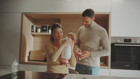 happy family with newborn baby in the kitchen