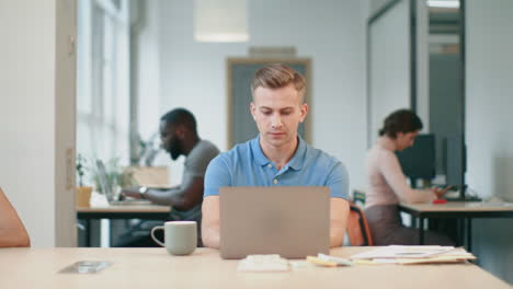 business man working on laptop at coworking. closeup portrait of serious man