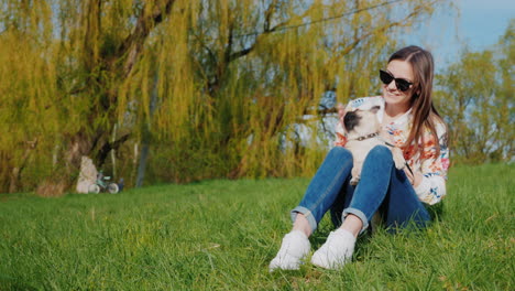 Junge-Frau-Ruht-Im-Park-Auf-Einem-Grünen-Rasen-Sitzen