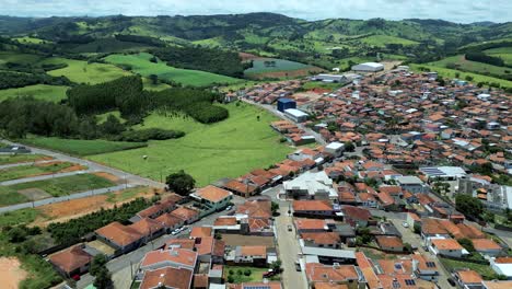 dolly reverse aerial view of bueno brandao, an agriculture city in serra da mantiqueira, minas gerais, brazil