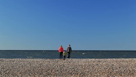 Family-of-three-on-pebble-beach