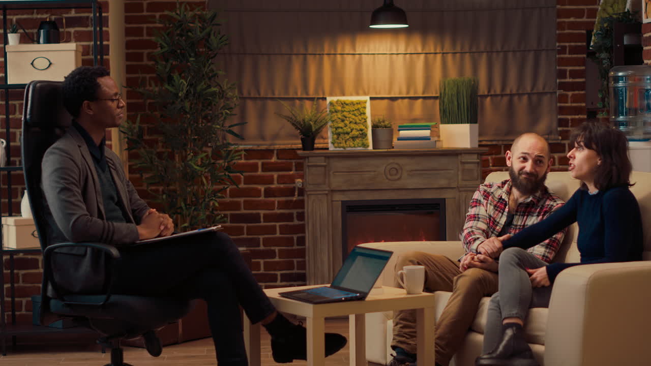 Married people making up after conflict at therapy session