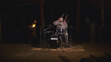 masked drummer at night