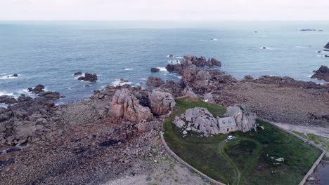 Forward-Drone-Shot-over-Brittany's-Shore-and-cute-House-Stuck-in-the-Rocks,-Low-Tide,-France,-gouffre-de-plougrescant