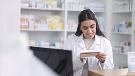 Pharmacist-working-on-computer-at-a-pharmacy