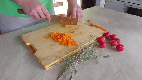 choping orange carrots on bamboo cuting plate with japanese ryukiri nakiri knife