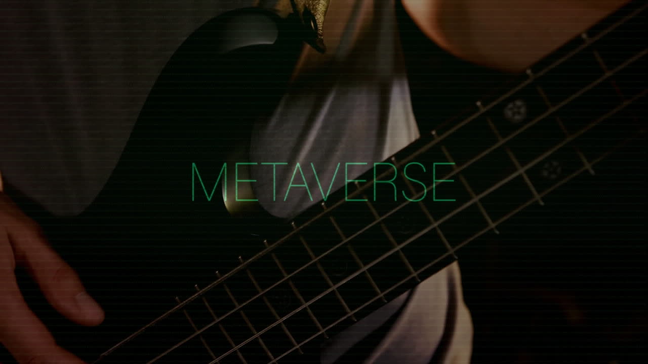 Male musician playing bass guitar in music technology studio, displaying green METAVERSE overlay
