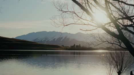 golden sunrise over lake with mountains in background