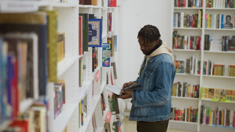 student standing in front of bookshelves in modern library, focused on selecting books, surrounded by rows of colorful books, exploring options for academic and personal reading in calm environment