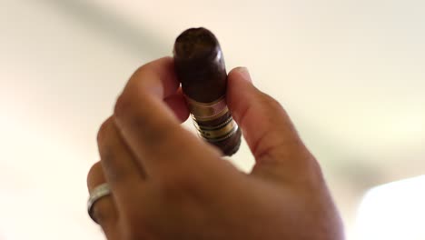 Close-up-shot-of-an-unsmoked-cigar-being-held-by-a-Caribbean-male's-hands