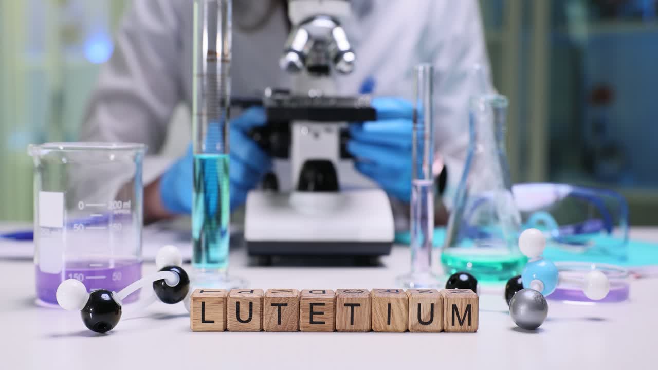 Miniature wooden cubes on laboratory table form term lutetium