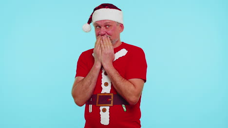 man in christmas t-shirt sending lots of air kisses looking at camera and smiling, missing you, love