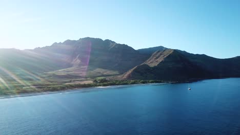 Drone-Shot-showing-the-beautiful-Makua-Valley-and-Makua-Beach-at-sunrise-on-Oahu,-Hawaii