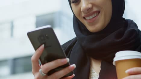 Woman in hijab using mobile phone in the city 4k