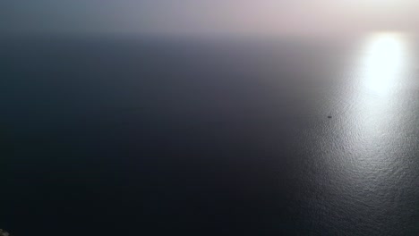 Lonely-boat-in-the-sea-at-sunset