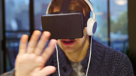 man using virtual reality headset at home