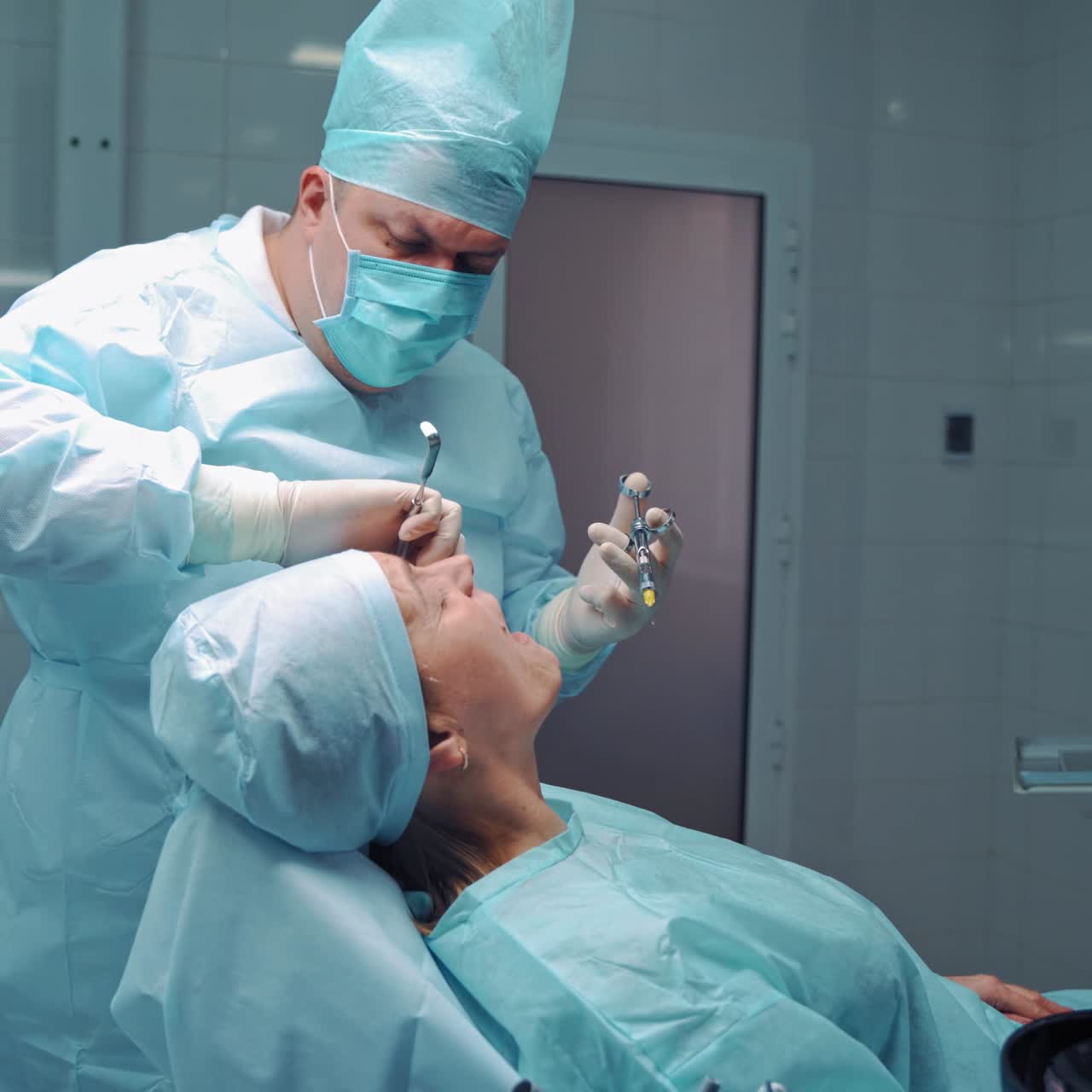 Dentist operating oral cavity of patient