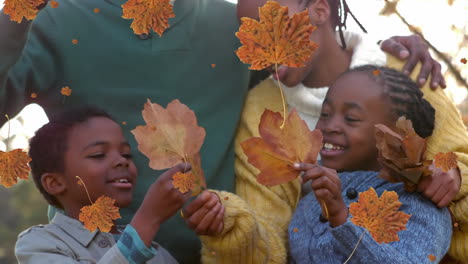 animation of autumn leaves falling over happy african american family in park