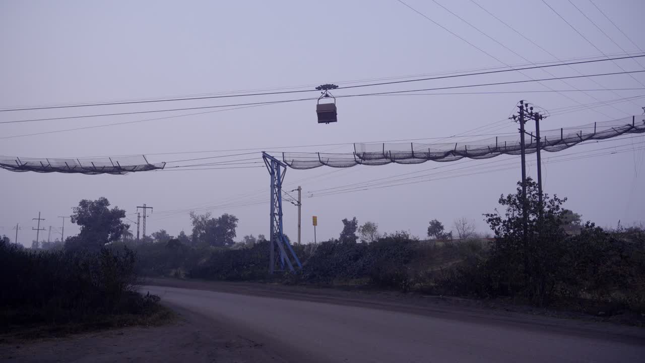 Industrial Cable Transport System and Power Lines on a Hazy Day