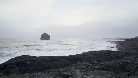 Waves-breaking-on-rocky-coastline-with-black-beach-of-Iceland