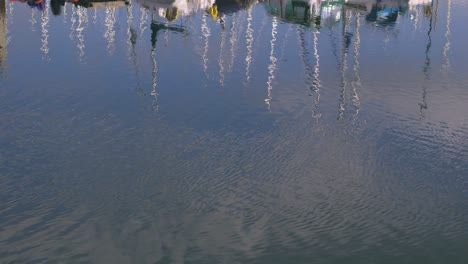 fishing boats reflected in the water in the morning