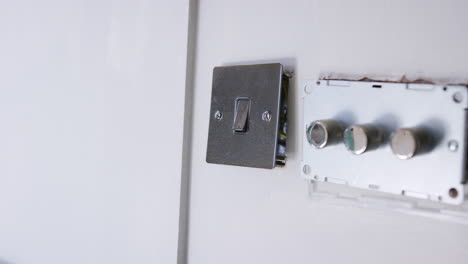 close up of electric light switches and dimmers being fitted