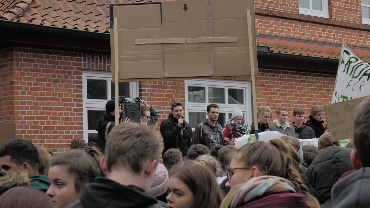 Young guy giving a speech in front of an audience