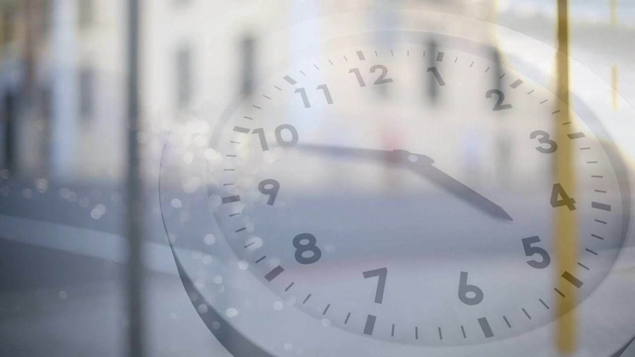 Vertical video: Coming from left walker in pink top with bag crossing street clock overlay rotating