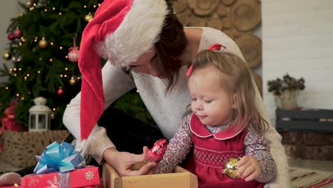 mother and daughter playing with christmas decorations