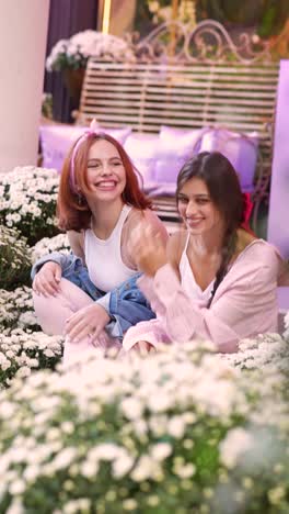 two young women enjoying time outdoors among flowers