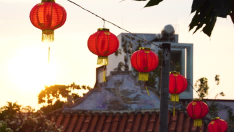 chinese red paper lantern hanging and swaying in wind at sunset