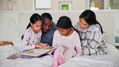 parents, girl children and bed with book