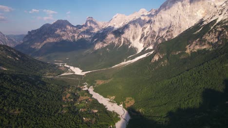 valley of alpine spot in albania, riverbed surrounded by high mountain peaks in valbona