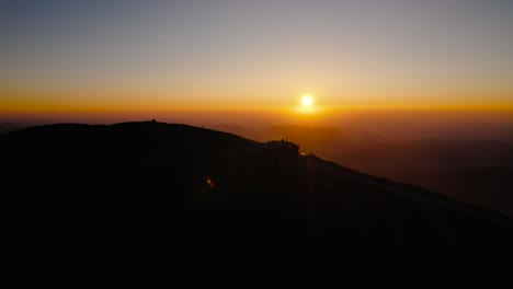 from the serene embrace of dawn to the mesmerizing hues of sunset, a visual journey over austria's majestic peaks and valleys, where the orange light transforms the scenery into a surreal dreamscape